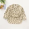 Baby long sleeve waterproof PU bib with cute dot pattern, soft and easy to clean feeding apron. - Size S for 6-12 Months / PU Top Pocket Bib with Beige Background and Big Black Dots