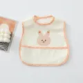 Cute waterproof baby bib with cute bunny print and food catcher pocket for toddler feeding time. - Orange Rabbit
