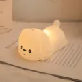 Adorable cartoon puppy silicone night light emitting warm ambient glow on bedside book - Lying Dog Silicone