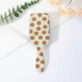 Retro floral print cushion hair brush anti-tangle scalp massage styling comb detail view. - Letter C