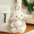 Cute plush lamb keychain dangling on a backpack, soft stuffed animal bag charm accessory. - Head-Tilting Sheep Pendant / 15cm / Cream