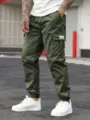 Men's military green cargo pants detail view featuring functional side pockets and cuffs. - S / Army Green
