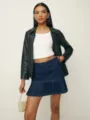 Women's denim mini skirt detailed view, featuring tiered ruffles and dark blue wash, casual style. - S / Blue