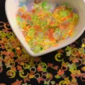 Close-up detail of colorful holographic nail art sequins, star heart butterfly shapes glitter. - Mixed Styles / Mixed Specifications / Random Mixed Colors