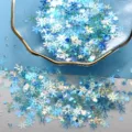 Gros plan de paillettes de flocon de neige bleu mélangées pour loisirs créatifs et déco. - Série Bleu Lac