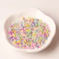 Close-up detail of colorful mixed seed beads in a white dish, perfect for DIY jewelry making. - 2mm Cream Seed Beads 20g