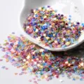 Detailed shot of 3mm colorful star sequins glitter for DIY epoxy resin and nail art crafts. - Gold Glitter Style - Mixed Colors