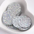 Close-up detail of 25mm holographic round sequins with side holes for DIY crafts and apparel. - Laser-Silver