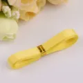 Yellow satin ribbon roll for DIY handmade crafts, beautiful gift wrapping and decor accessories. - Yellow