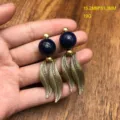 Close-up of vintage style blue bead and golden leaf dangling earrings with fine textured design. - Lapis Lazuli Stud Earrings