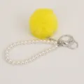 Cute yellow plush pom pom pearl bracelet keychain detail view showing fuzzy ball and metal rings - Yellow Pompom Pearl Keychain