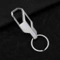 Detailed close-up of the silver metal car keychain with geometric hook and round ring. - Nickel Color