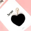 Black heart faux fur keychain pom pom charm with gold hardware detail close up view - Black