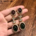 Pendientes colgantes ovalados estilo dopamina vintage con pedrería brillante y acabado dorado. - Pendientes de botón