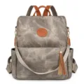 Damen lässiger Anti-Diebstahl Rucksack aus grauem PU-Leder mit braunen Akzenten und Quaste. - Grau
