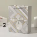 Elegant bow gift bag with white cardboard material, luxury geometric pattern for parties and gifts. - 18x10x23cm / Gray
