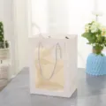 White paper gift bag with transparent window, elegant silver handles and decorative hangtag. - Small 18*13*25cm / White