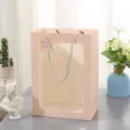 Pink paper gift bag with clear window and rope handles, elegant packaging for presents and events. - Small 18*13*25cm / Pink