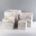 Detailed view of square marble pattern paper gift bags in multiple sizes for elegant packaging. - White Marble