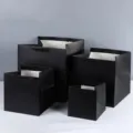 Detailed view of thick black square gift paper bags with wide bottom for retail and bakery packaging. - 15x15x15cm / Black