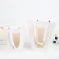 White trapezoid flower paper gift bag with clear window and ribbon handles for rose packaging. - S / White