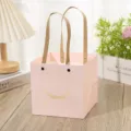 Pink square gift bag with window and cute smiley face cutout, perfect for flower packaging. - 10*10*10cm / Pink Smile Face