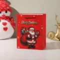 Detail view of red Christmas paper gift bag featuring cute Santa Claus and snowflake print. - Style 4 (696-4) / 18x10x23cm