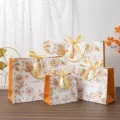 Gold floral gift bags with ribbons, elegant paper packaging for presents and parties. - Small (18x10x16cm)