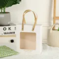 White windowed paper gift bag with golden text and woven handles for wedding party and favors. - L / White