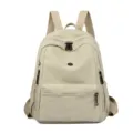 Sac à dos décontracté unicolore en nylon pour femme, sac de voyage léger avec poches zippées pratiques. - Gris clair