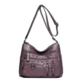Sac bandoulière en cuir PU violet avec multi-poches, sangle réglable et détail matelassé. - Violet