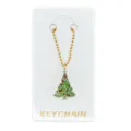 Detailopname van een strass kerstboomhanger met een gouden kralenketting op een kaart. - Kerstboom