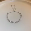 Close-up detail of sparkling crystal tennis bracelet with adjustable slider chain design. - 48# Bracelet - Silver - Geometric