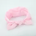 Close-up of soft pink fabric bow headband, delicate knot design, comfortable elastic hair accessory. - Light Pink