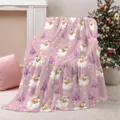 Close-up view of a cozy pink Christmas blanket featuring vintage Santa Claus and festive trees. - 75x100cm / Pink