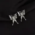 Close-up detail shot of silver liquid metal butterfly clip earrings with stylish Y2K aesthetic. - Large Butterfly Style
