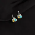 Close-up of quirky punk cat earrings featuring dual-color resin eyes and metallic finish. - Odd-Eyed Cat Style