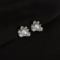 Close up shot of irregular metal pearl ear clips showing exquisite texture and shine. - Ruffle Style