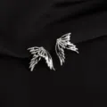 Detailed shot of edgy silver wing ear clips, showcasing intricate cutout feather details. - Wings Style