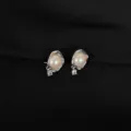 Detailed close-up showing the unique irregular metal pearl clip-on earrings with shimmering zircon. - Ruffle Iridescent Pearl Style