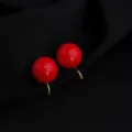 Close-up of wine red minimalist round clip-on earrings with gold finish, elegant detail shot. - Wine Red 14mm Artificial Pearl Mosquito Coil Clip