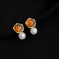 Close up detail of retro amber and pearl drop earrings, elegant gold-plated geometric design jewelry. - Wine Red Maillard Artificial Pearl Mosquito Coil Clip