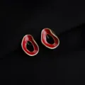 Close-up detail view of irregular gold-rimmed red enamel clip-on earrings, elegant retro style. - Wine Red Hollow Geometric Mosquito Coil Clip