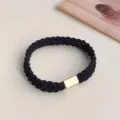 Detail closeup of black braided hair tie with elegant gold metal accent and high stretch. - Black Woven Style (3374) / Black