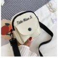Canvas crossbody bag, beige small shoulder bag with black strap and embroidered letter design. - White
