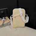 Yellow canvas crossbody phone bag with cute star studs and adjustable white strap variant. - Creamy Yellow