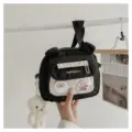Black nylon crossbody bag with cute bear ears, clear front pocket, and lovely plush pendant. - Black