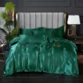 Emerald green silk bedding set detailed view, luxury hotel style bedroom scene presentation. - 1.2m Ice Silk Bed Sheet 4-Piece Set (Duvet Cover 150×200cm) / Emerald Green