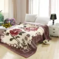 Detail view of winter warm Raschel plush blanket featuring elegant rose floral pattern. - Dusty Rose