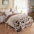 Detailed view of winter plush raschel blanket with geometric block pattern in cozy bedroom. - Black & White Style